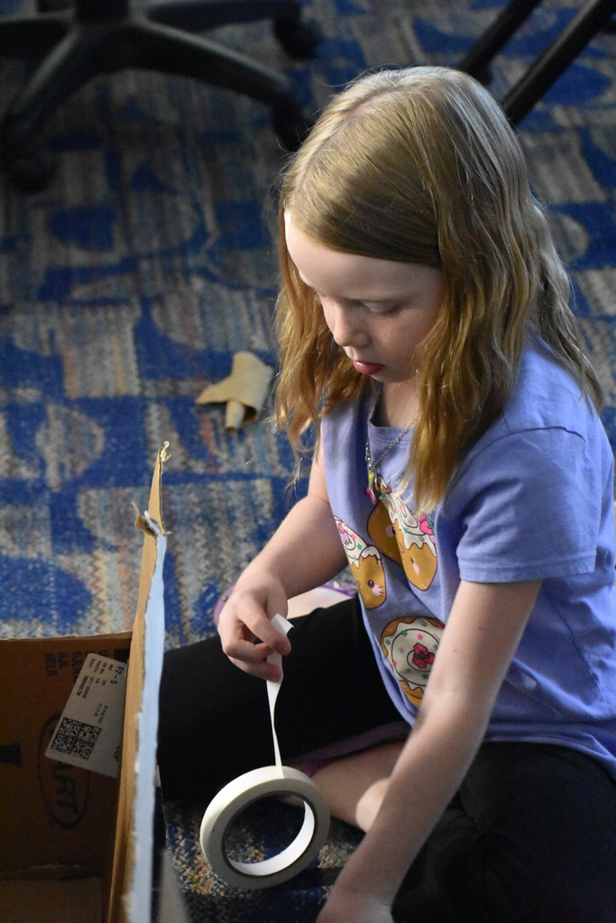 A student working on a box construction project