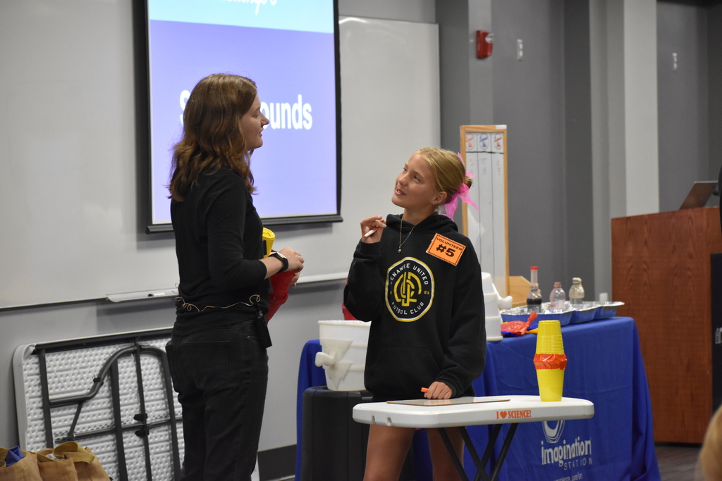 A student answering a question to the Imagination Station employee