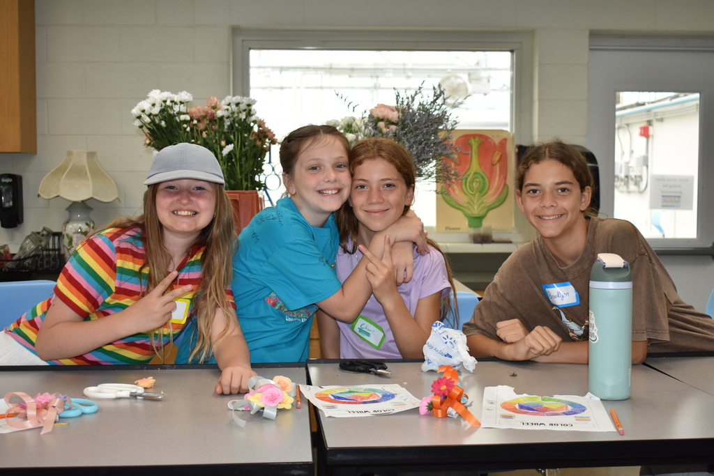 Four students posing together and smiling at the camera