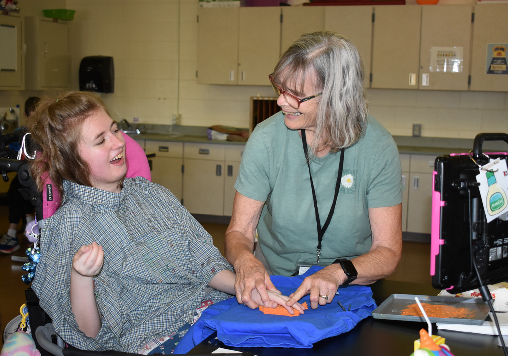 A student and teacher making a shirt together