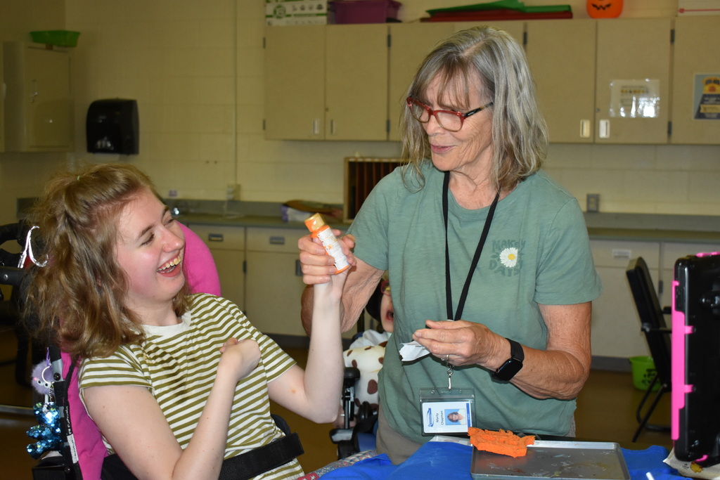 A student and a teacher making a shirt together