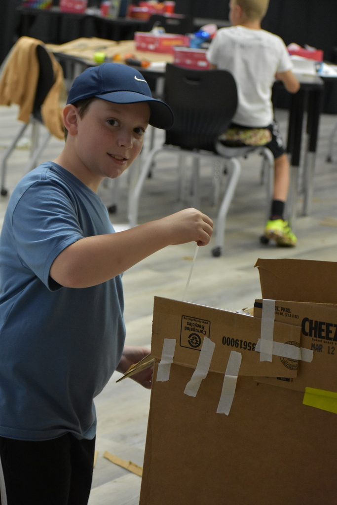 A kid posing with the game he made