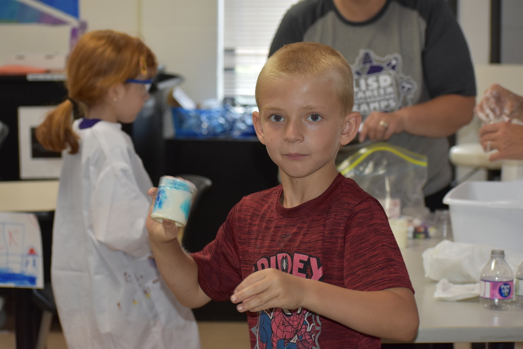 A young boy shaking his dye into his goo