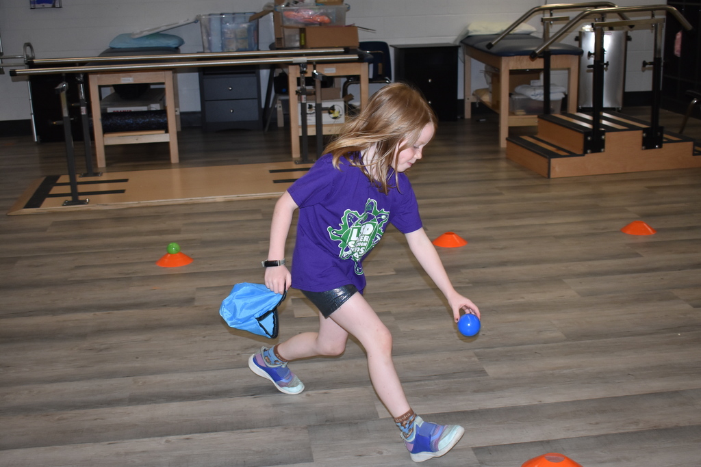 A young girl doing an obstacle course