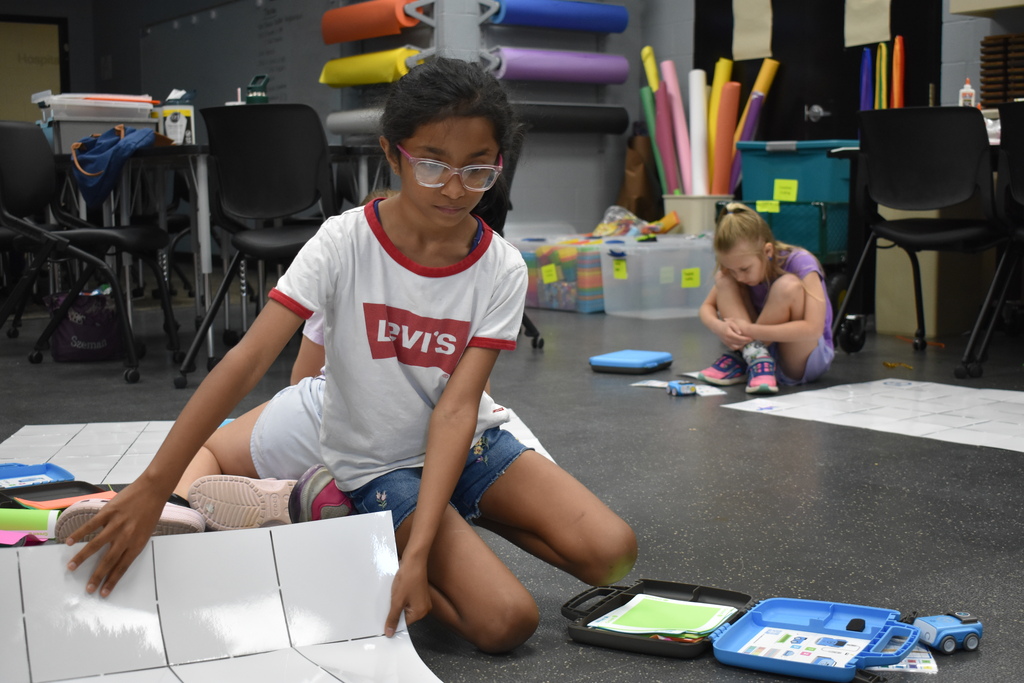 A student setting up her coding robot