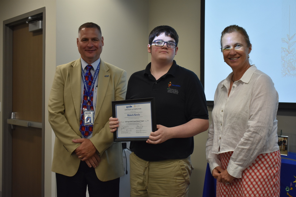 The superintendent and president of the hospital with a graduate