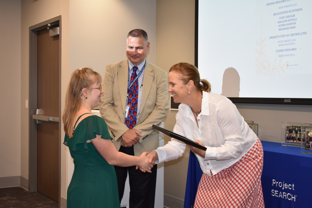 The superintendent and president of the hospital with a graduate