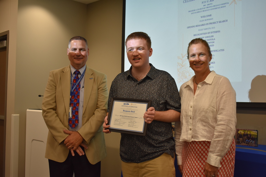 The superintendent and president of the hospital with a graduate