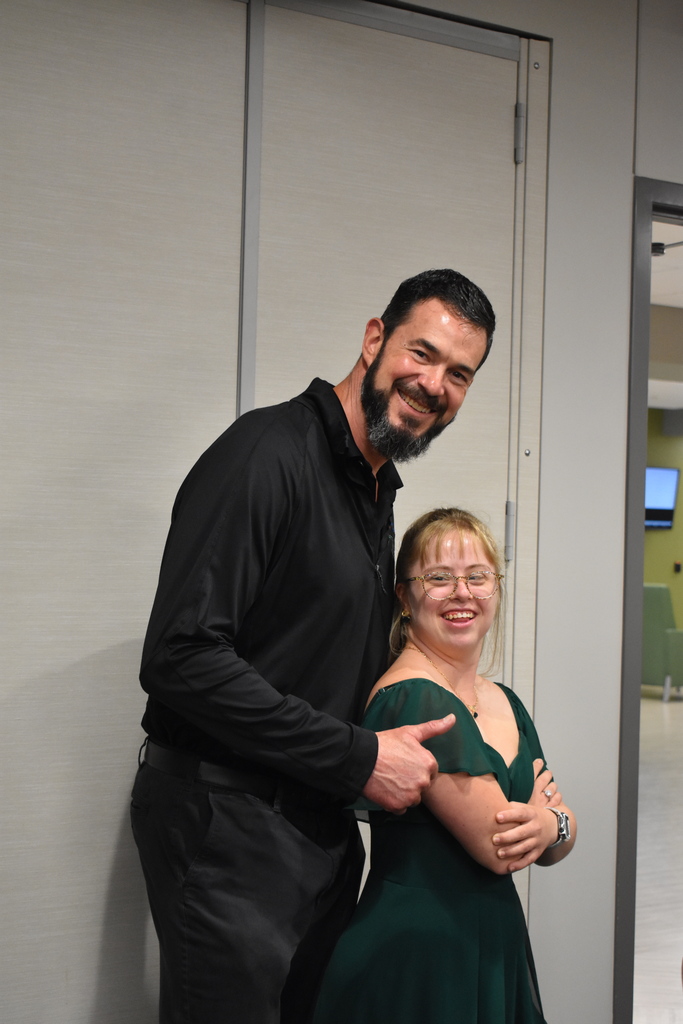 The program director and a student posing for a photo