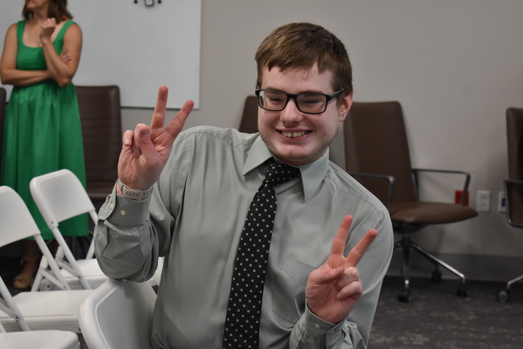 A student giving a double peace sign to the camera