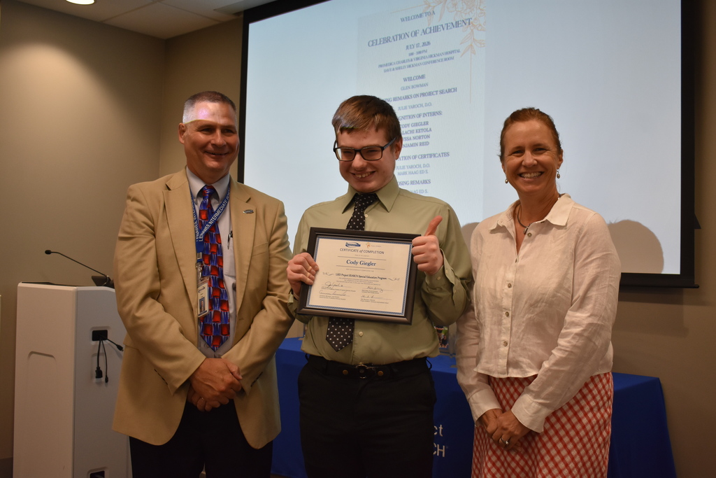 The superintendent and president of the hospital with a graduate
