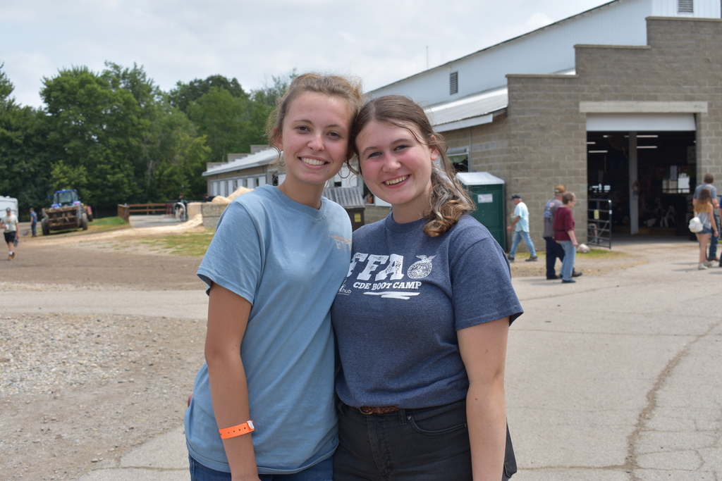 Two FFA TECH Center students posing for a photo together outside at the Lenawee County Fair