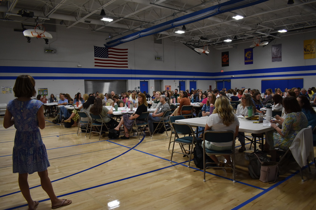 A full group photo of all of the LISD Special Education staff in the Porter Gym at tables