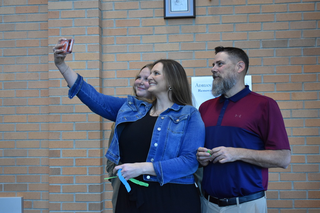 A family takes a selfie together in the foyer at Opening Day