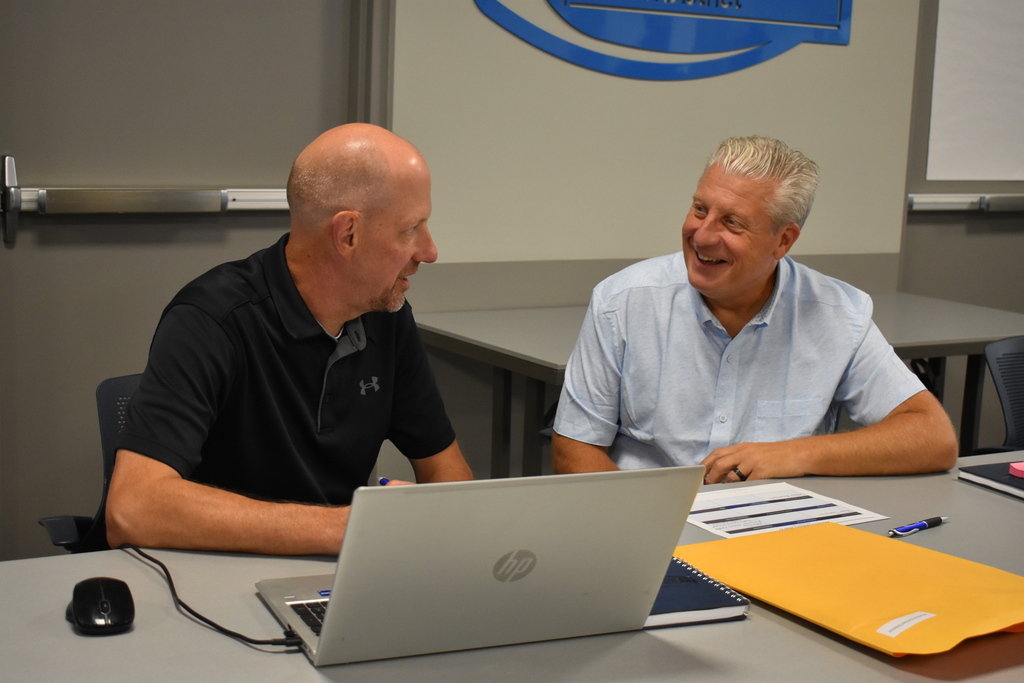 Hudson and Sand Creek's superintendents seating and chatting together