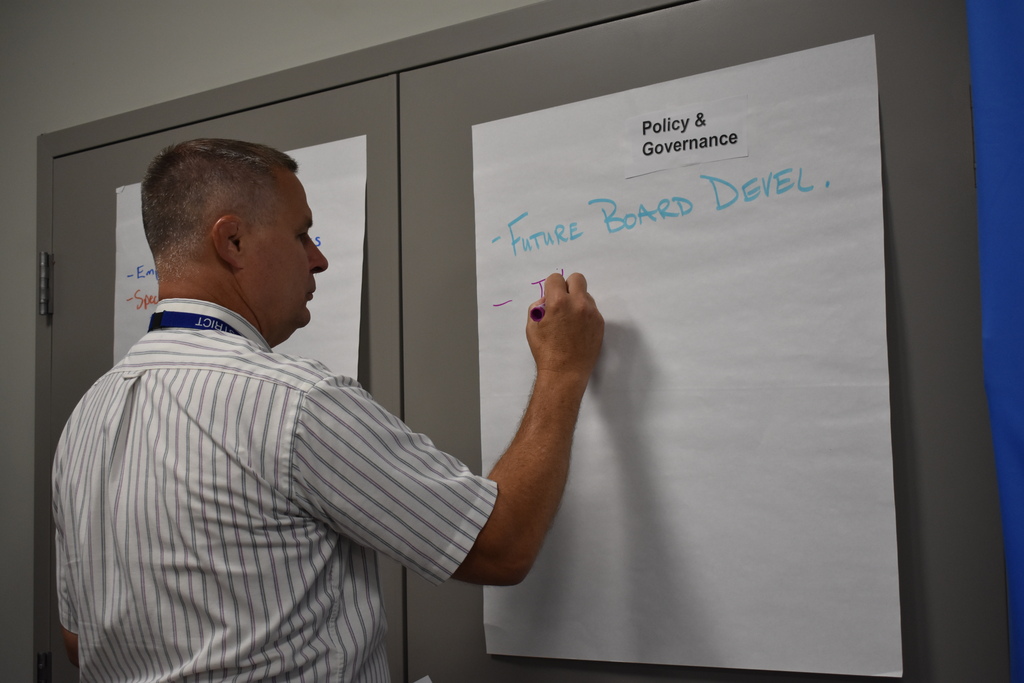 LISD's superintendent writing on a blank sheet on the wall