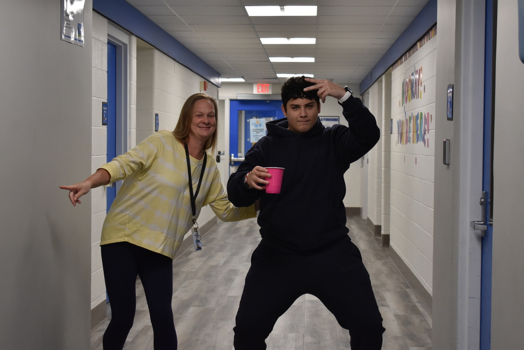 A student and teacher posing in style in the hallway at Haviland