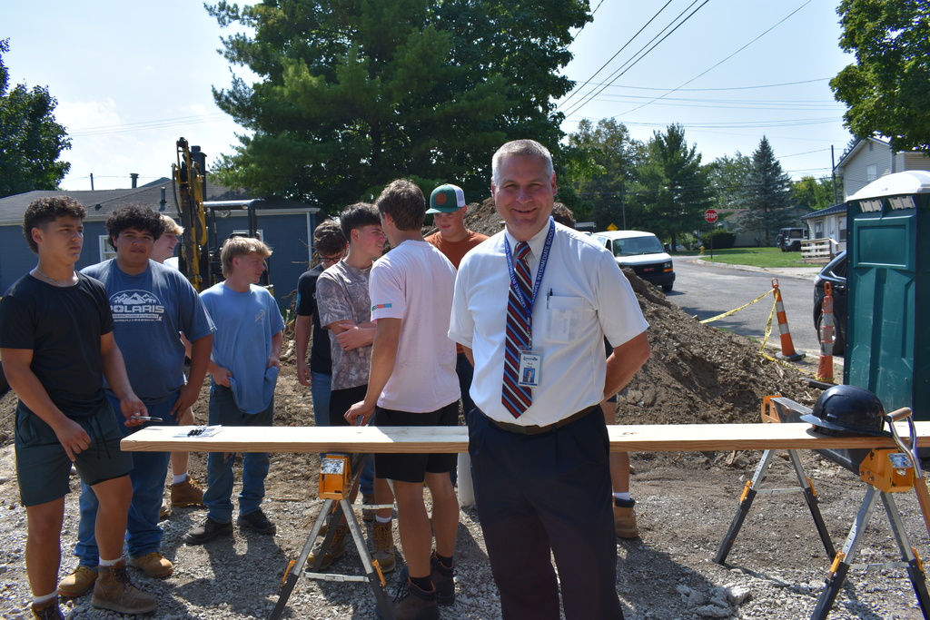 Superintendent Mark Haag on the site with students standing behind him