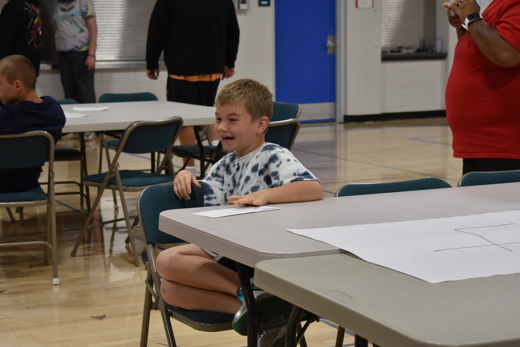 A student smiling and laughing at something someone said