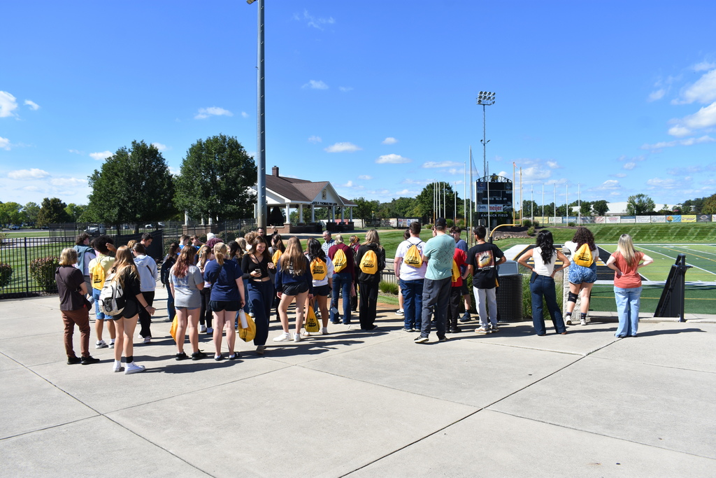 All of the JC LISD Academy students on a tour listening to a guide as he explains the football stadium that they are all looking at