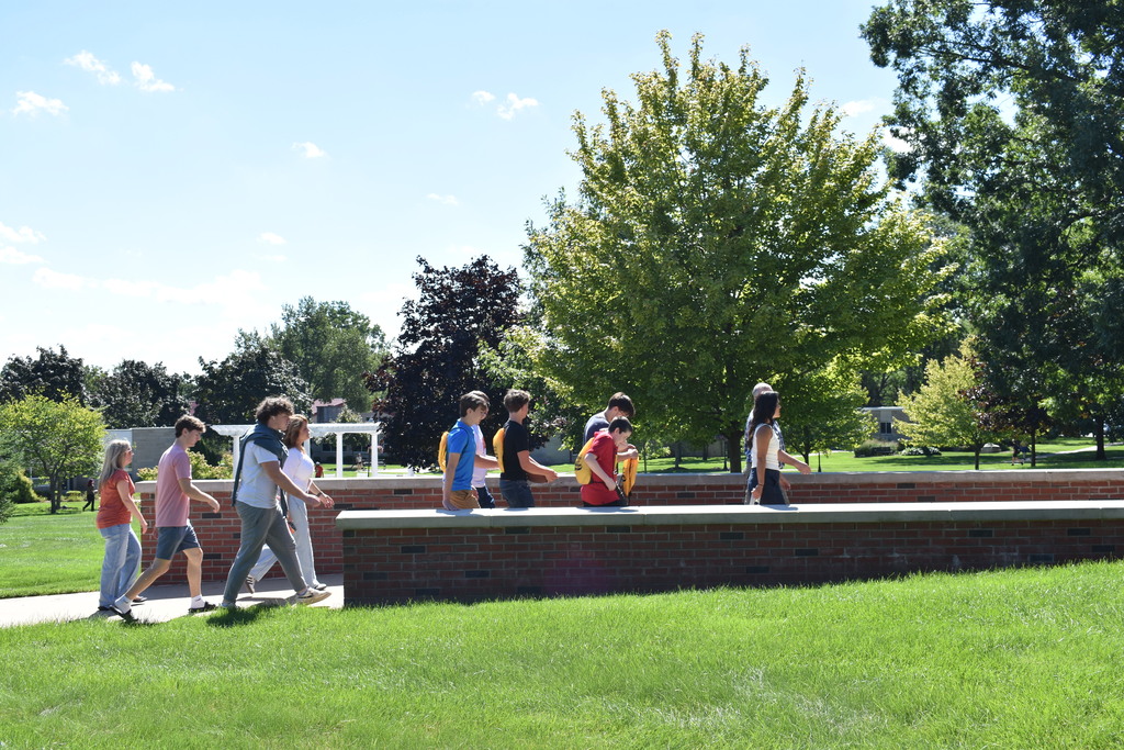 Teachers and students from the Academy walking across campus