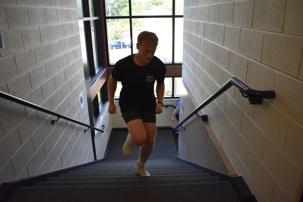A student running up the stairs