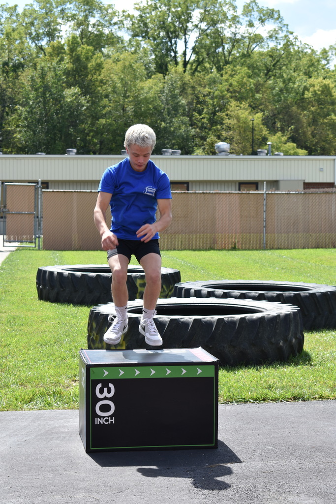 A student completing a box jump