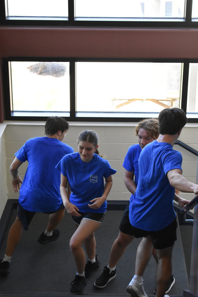 Students running up and down a staircase