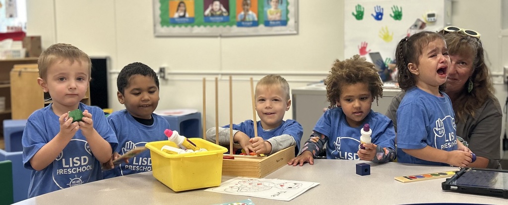 Students at a table with their PBIS shirts on.