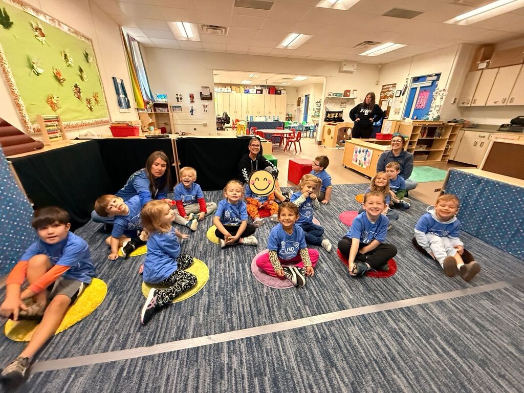 GSRP classroom students seated on the floor wearing their blue PBIS shirts.