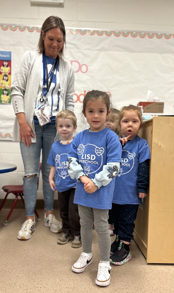 Students standing with PBIS shirts on.