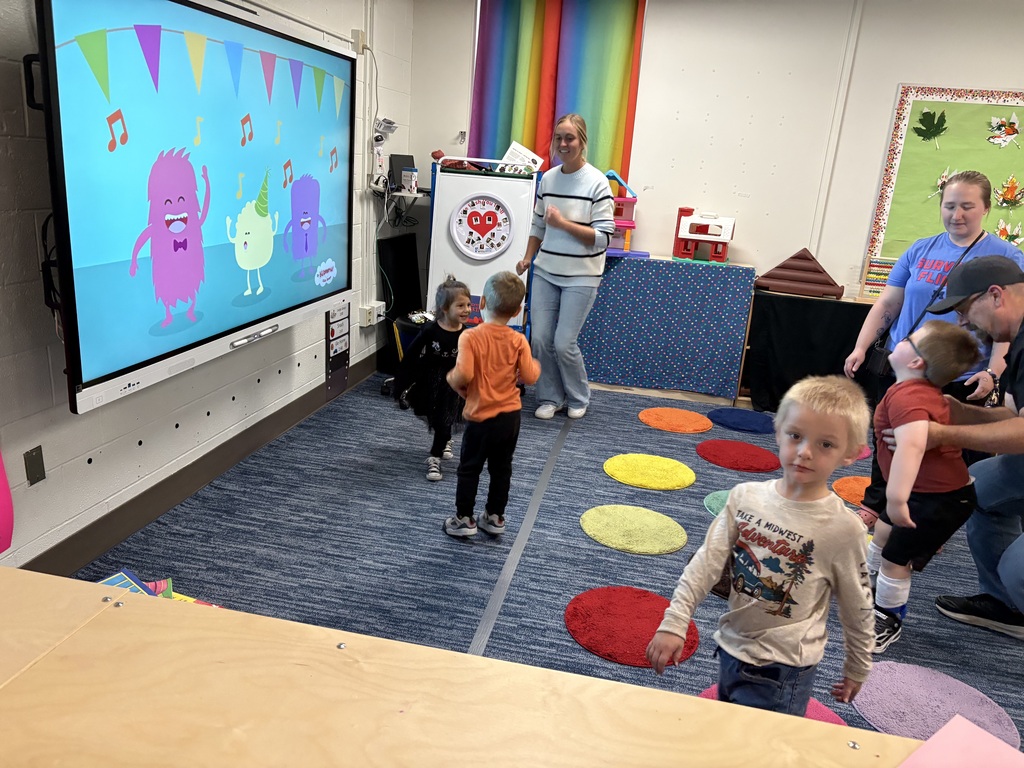 Students, families, and teachers enjoying a dance party.