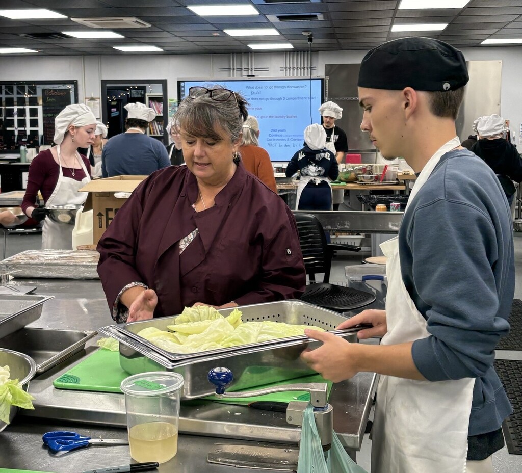 Culinary Instructor and student make Cabbage Rolls
