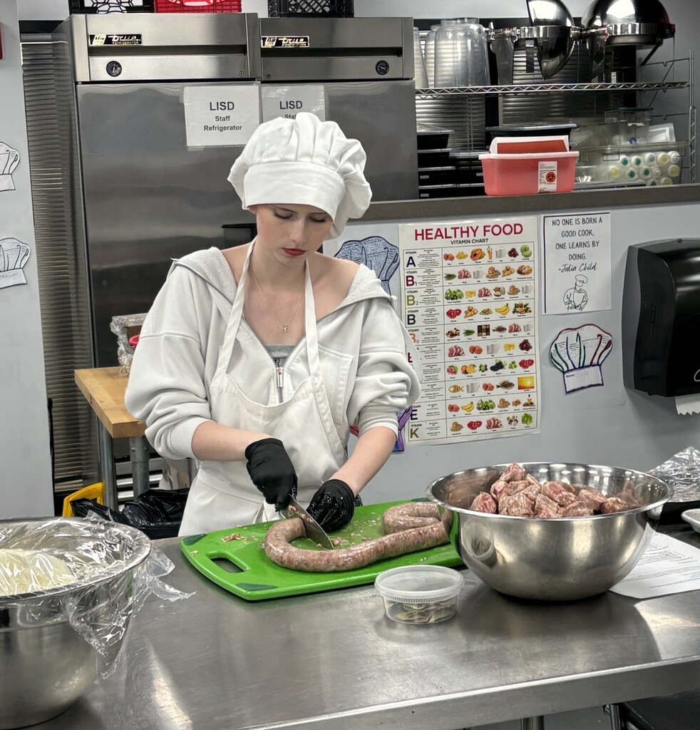 TECH Center Culinary student shows off knife skills with sausage