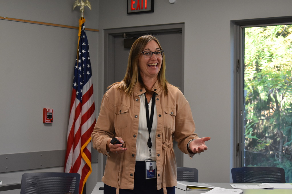 An LISD presenter smiles and gestures while speaking to educators during a Secondary Literacy Network training session.
