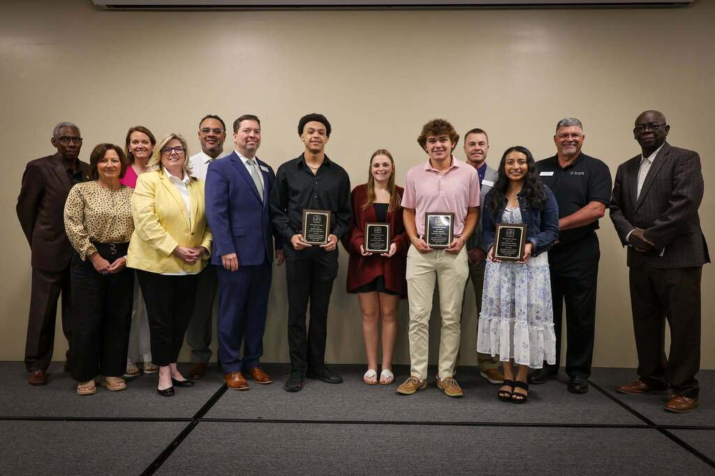 Students stand with Board members after winning the LCSAEOP scholarship