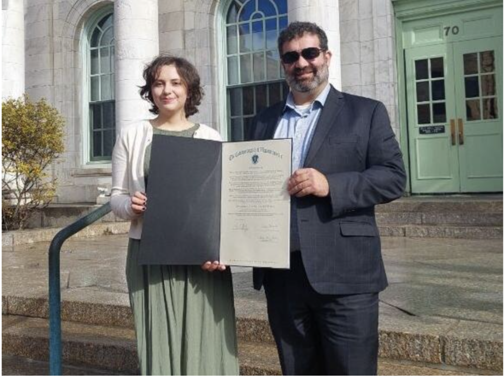 Amelia Gilardi accepts the proclamation she requested from Gov. Maura Healey from state Sen. Paul Mark outside Pittsfield City Hall Friday.