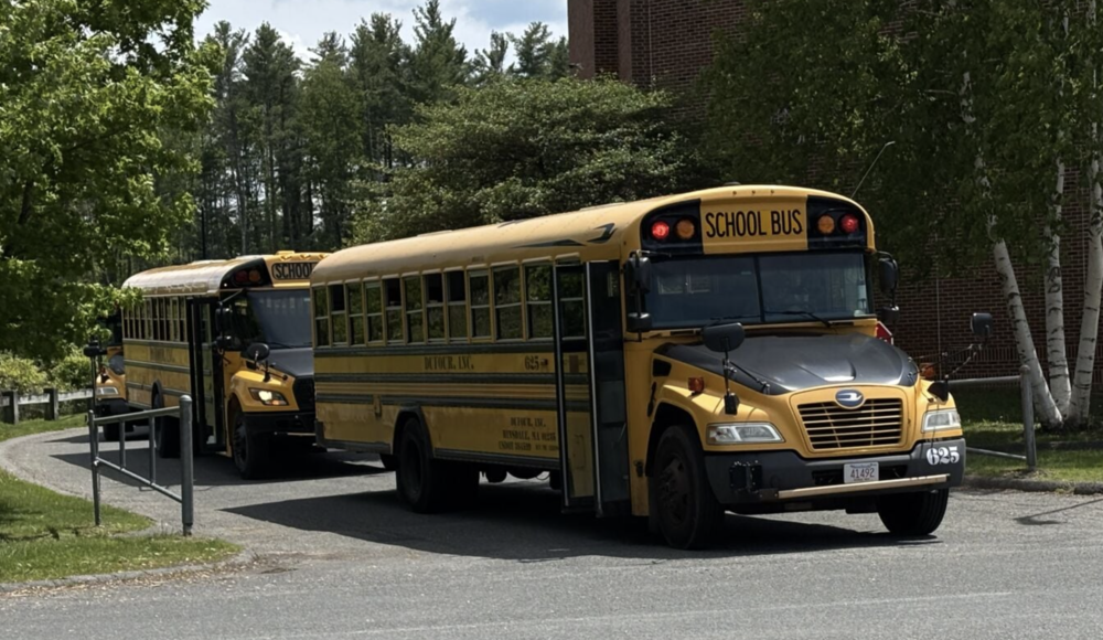 School buses line up Tuesday outside Lenox Memorial Middle and High School. Town voters will be asked wither they support opting in to a state law allowing installation of stop-arm cameras to record license plate numbers of motorists passing a stopped school bus with warning lights on.