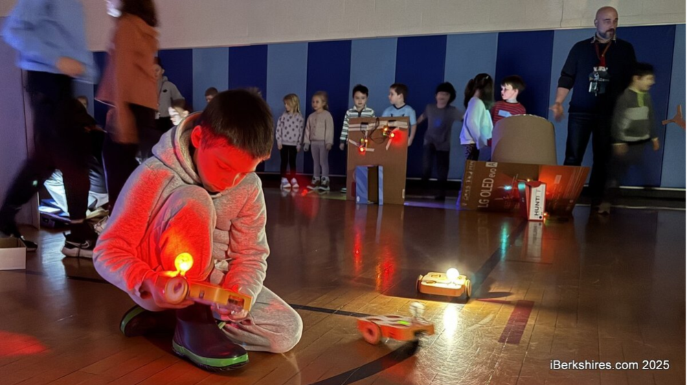 A Morris Elementary pupil examines one of the technology classes' light show objects in the gym.