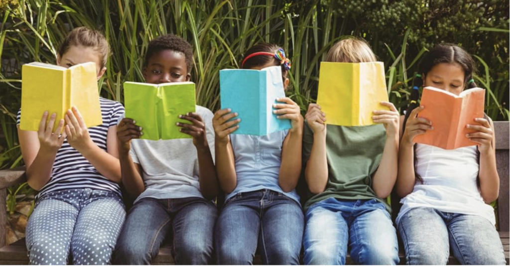 Students sitting in a row reading books - National Book Lovers' Day.