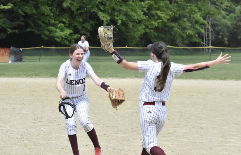Lenox pitcher Cassidy Flynn greets Lilly MacDonald with a big smile and a hug after MacDonald grabbed the final two outs of the game. 