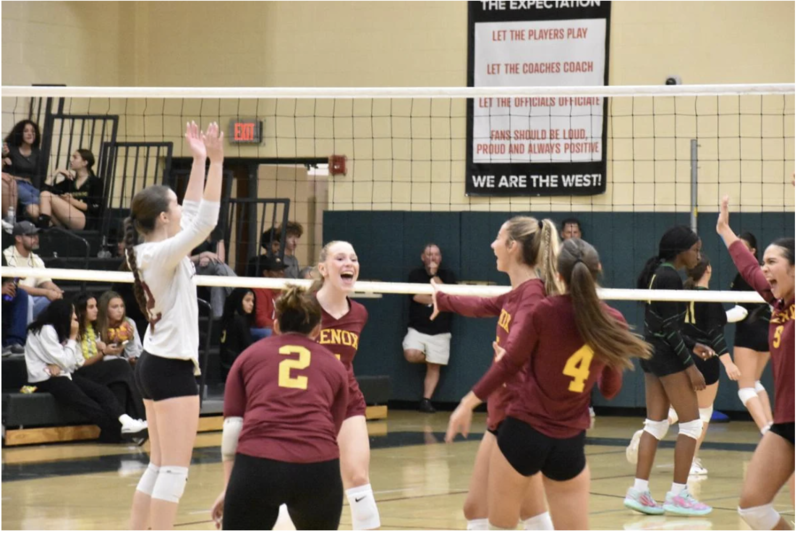 Lenox celebrates a big kill from Sara Isby (center).