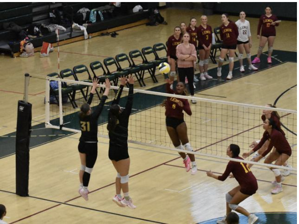 Lenox's Markiara Jackson spikes the ball as Taconic's Gracelyn Cormier and Kiera Yee go up to try and contest the shot.