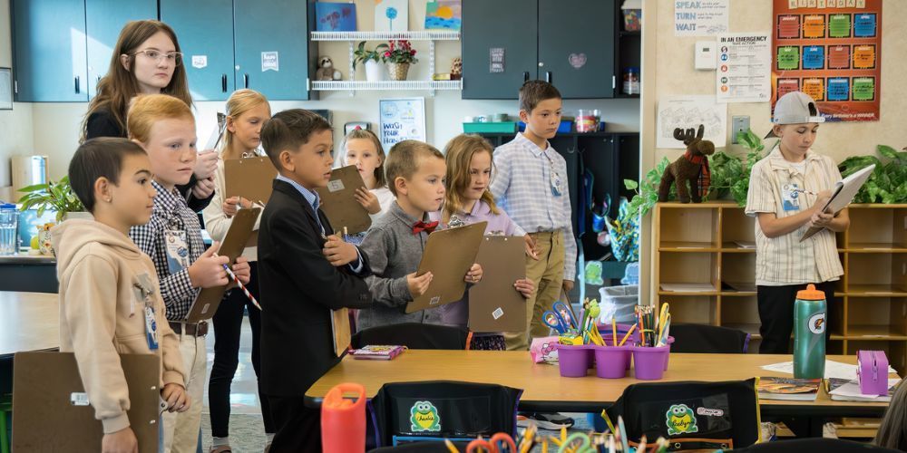A group of students got to be principal for the day at Prairie Winds Elementary. Here, they are observing other students work. 