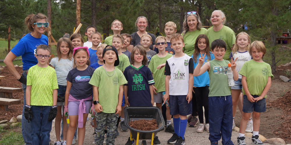 Lewis-Palmer Elementary students and staff members pose for a group picture after working outside