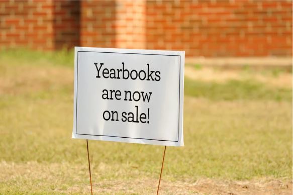 Image of a yard sign that says Yearbooks are now on sale!
