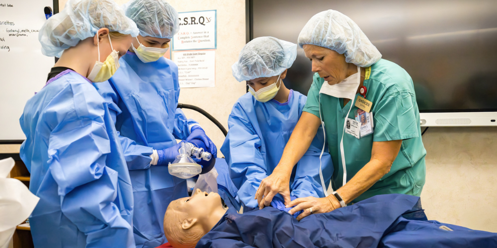 Students learn about CPR and medical care using a medical dummy