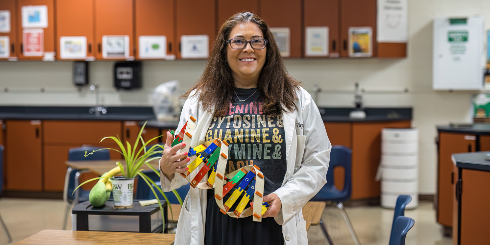 LPHS science teacher and HOSA advisor Monica Tupper poses for a picture in her classroom. She is holding a model of a DNA strand