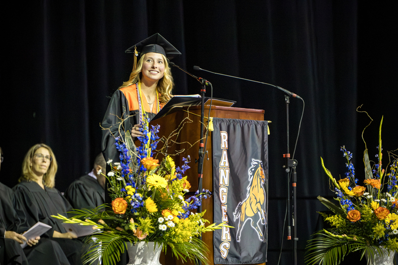 Female graduate speaks at the podium.