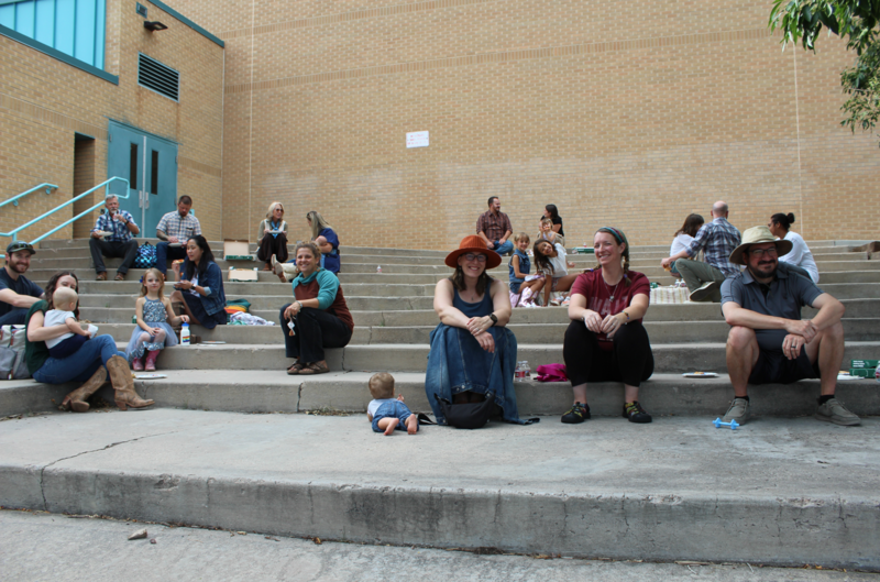 parents sitting and smiling outside of ples